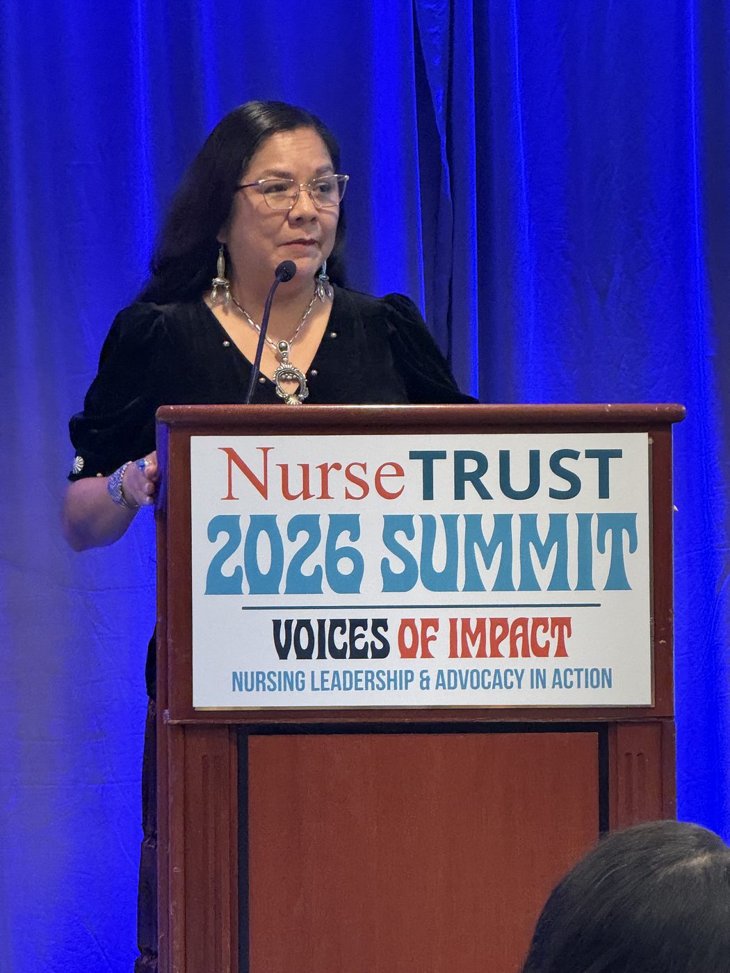 Speaker at the NurseTRUST 2026 Summit podium