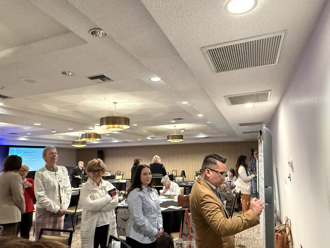 Conference room with attendees and exhibitors